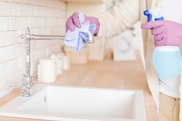 Free photo close-up man disinfecting sink