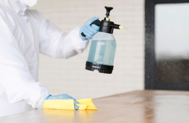 Free photo close-up man holding disinfectant bottle