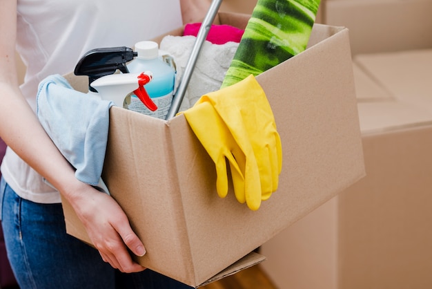 Free photo crop woman carrying box with things