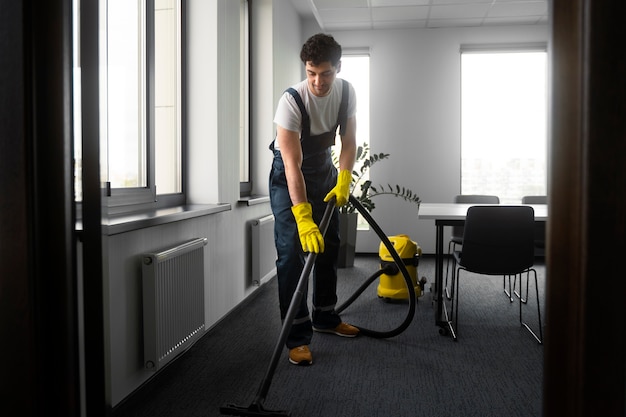 Free photo full shot man cleaning indoors