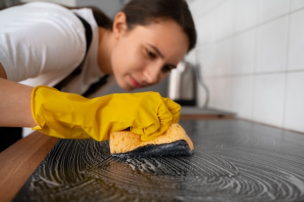 Medium shot woman cleaning home