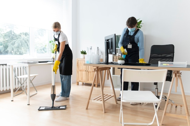 Free photo people taking care of office cleaning