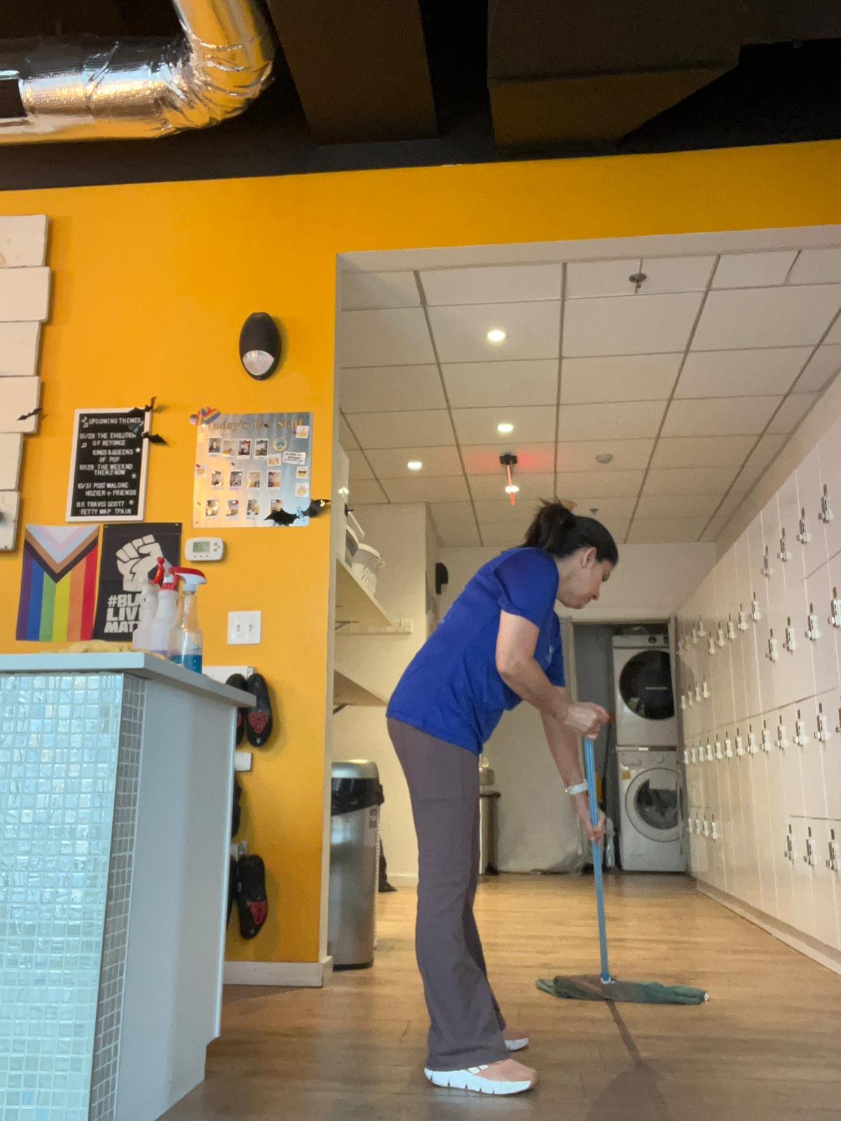 BraBos Cleaning team member mopping the floor at The Handle Bar Gym