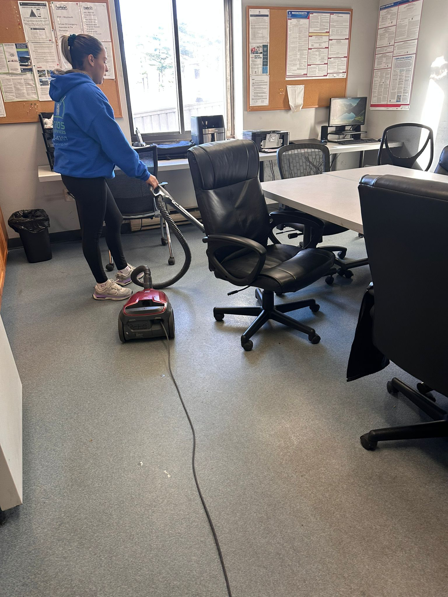 BraBos Cleaning team member vacuuming an office space