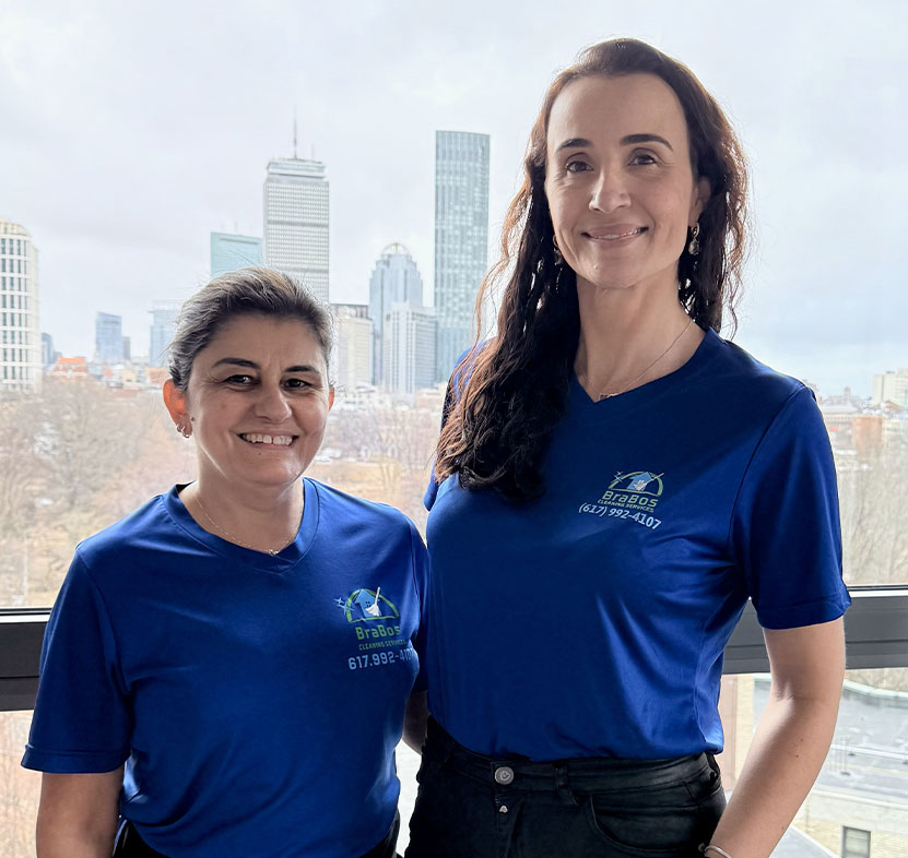 Two Brabos Cleaning staff members proudly standing after delivering a 100% happiness guarantee cleaning service in Boston